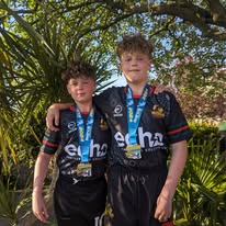 Young athletes proudly wearing their medals after competition